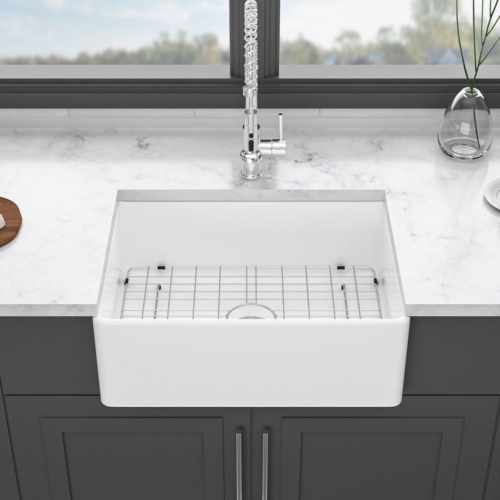 White farmhouse apron-front single-bowl ceramic kitchen sink with strainer and rack