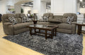 Gray power reclining sofa with built-in headrests and patterned accent pillows