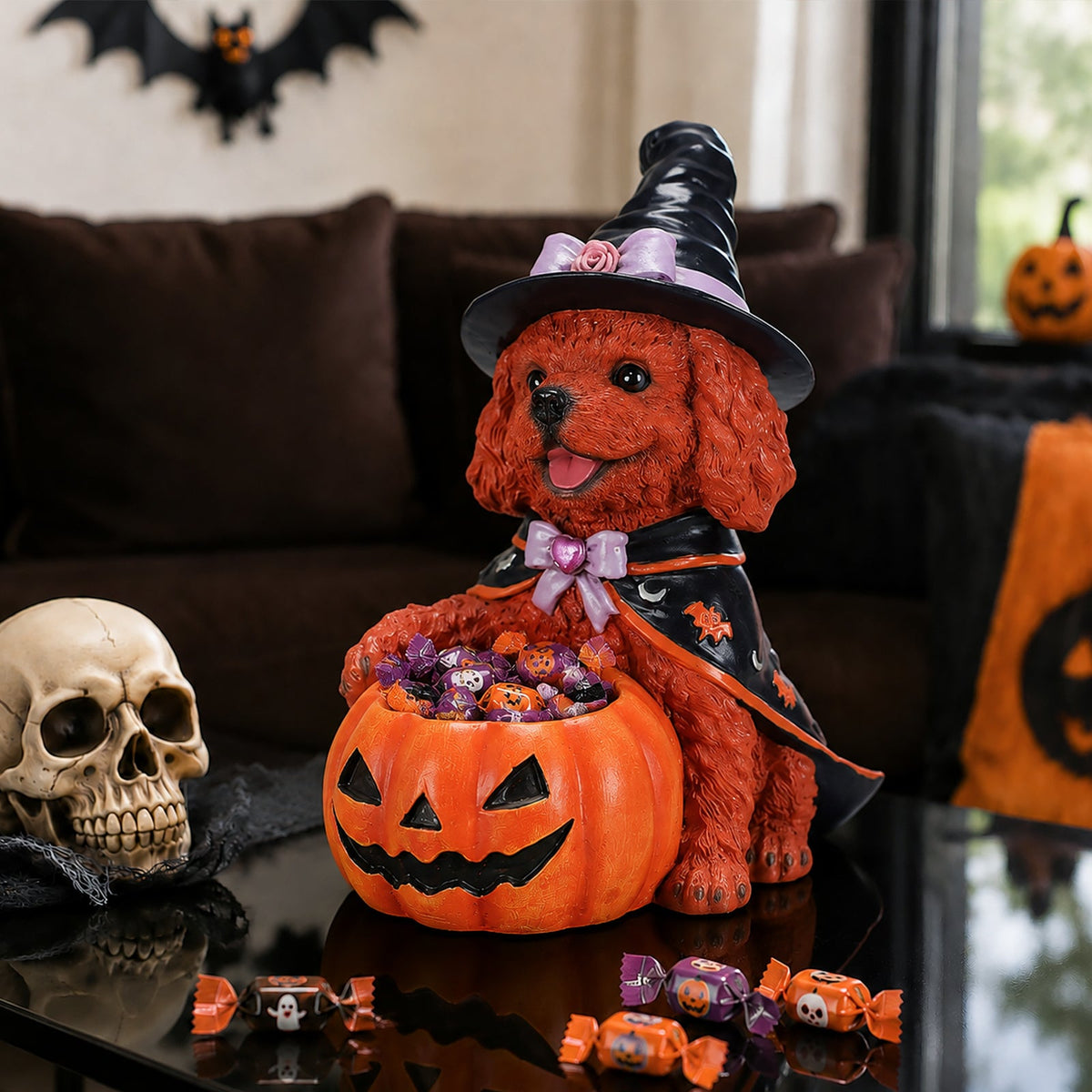 Angled view of a brown dog witch figurine with a candy-filled pumpkin bowl