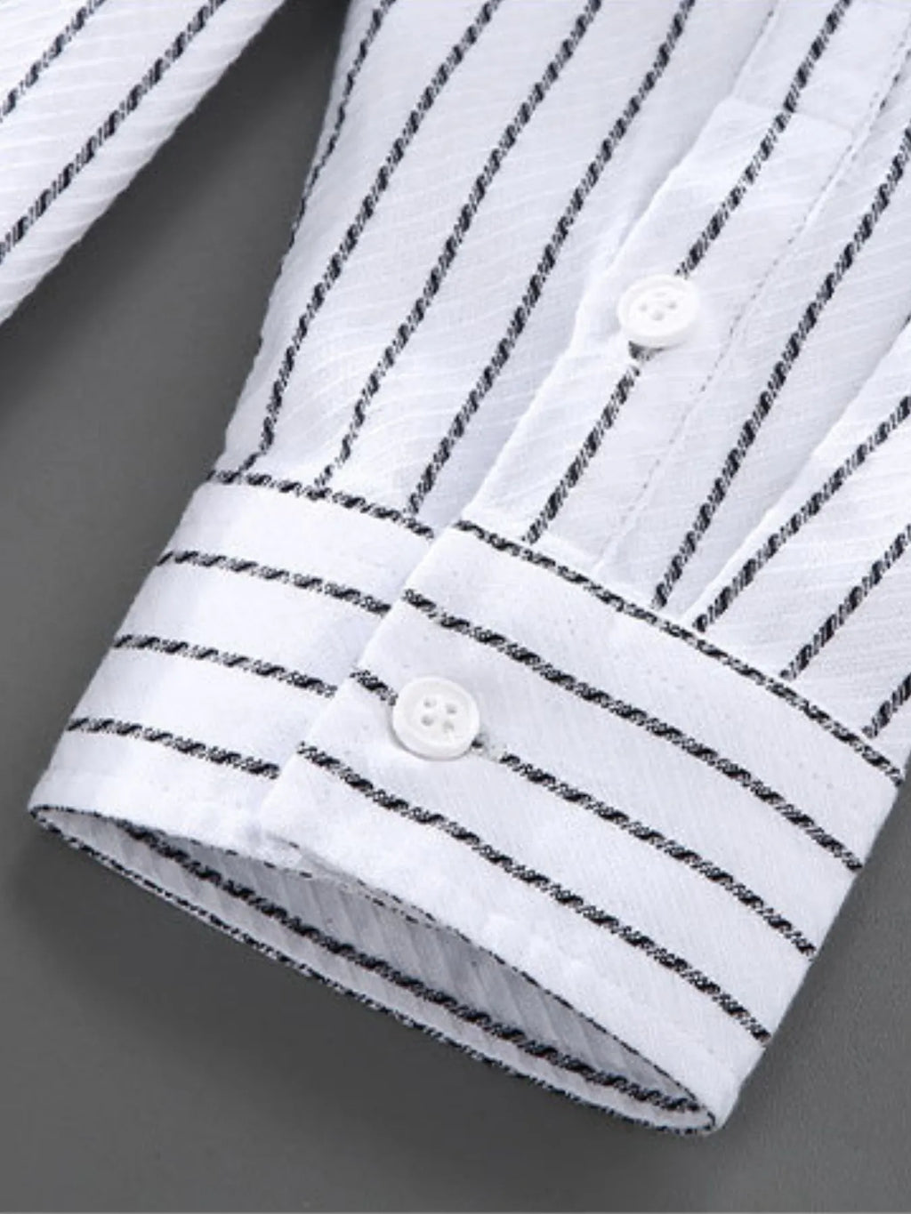 White long-sleeve cuff with black pinstripes and two button details