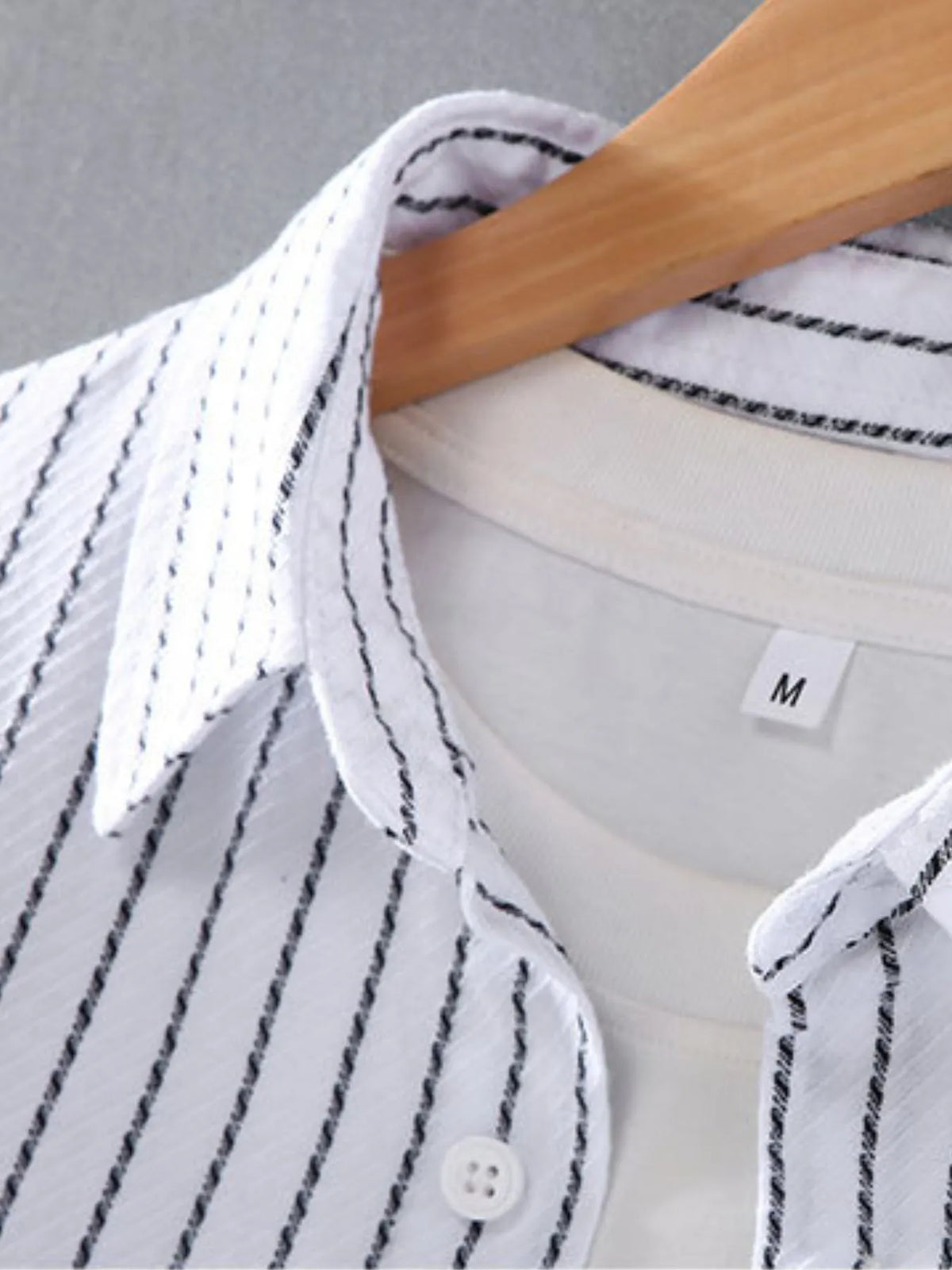 White pinstriped shirt front with button placket and size label
