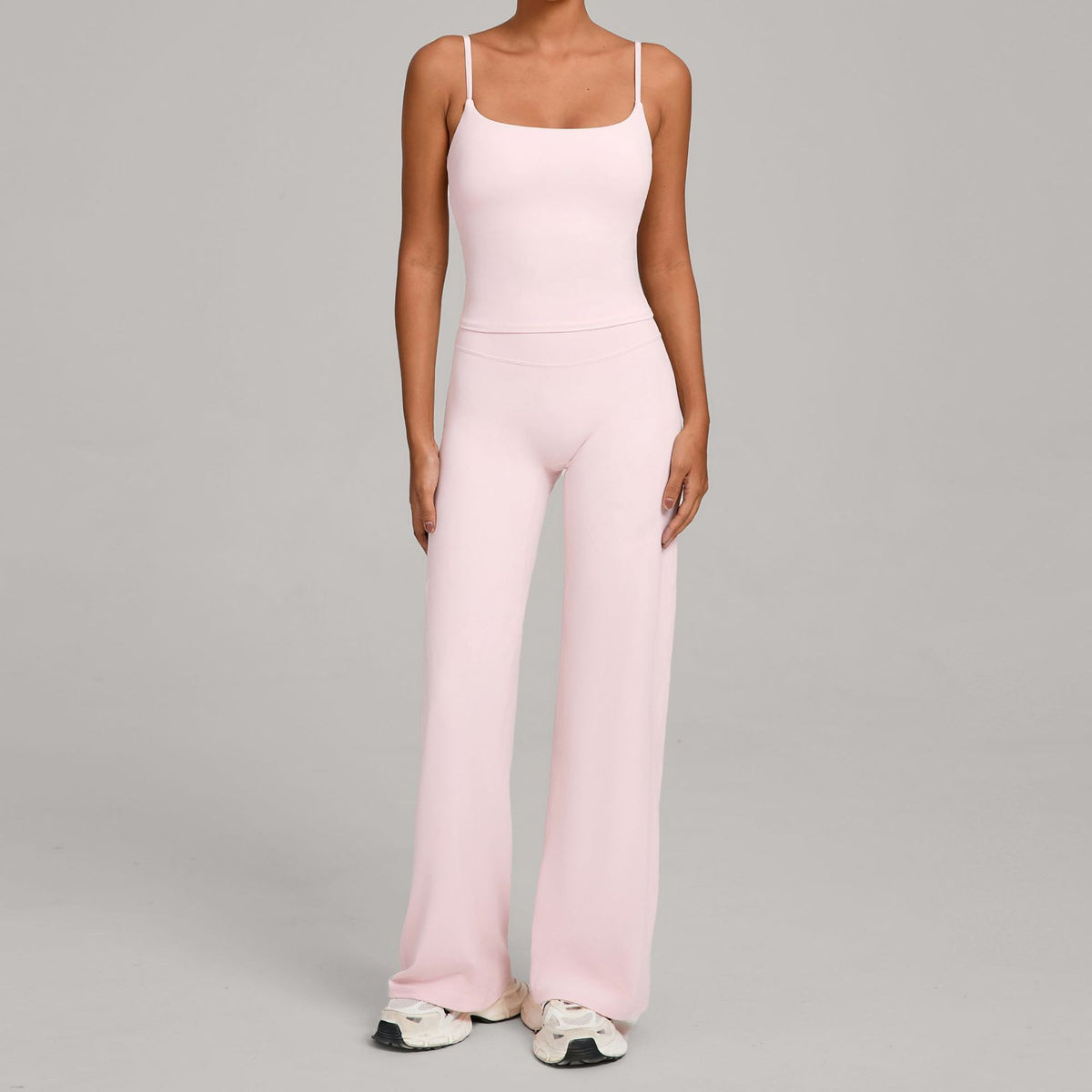 Women's yoga suit in light pink, spaghetti-strap crop top and wide-leg pants
