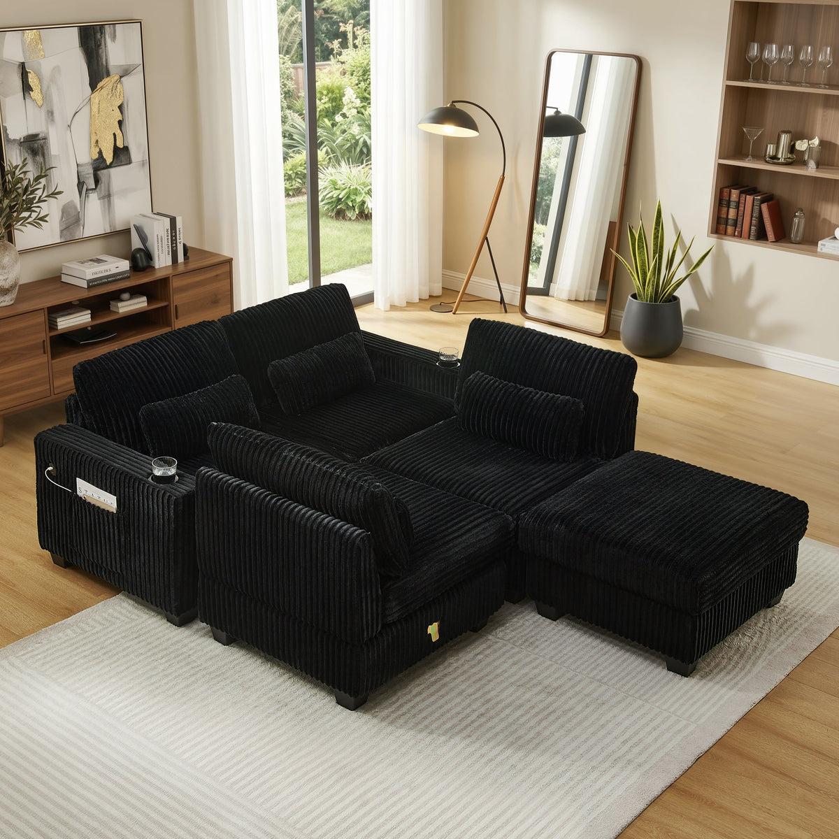 Black corduroy modular sectional sofa with chaise and detachable footrest, angled view