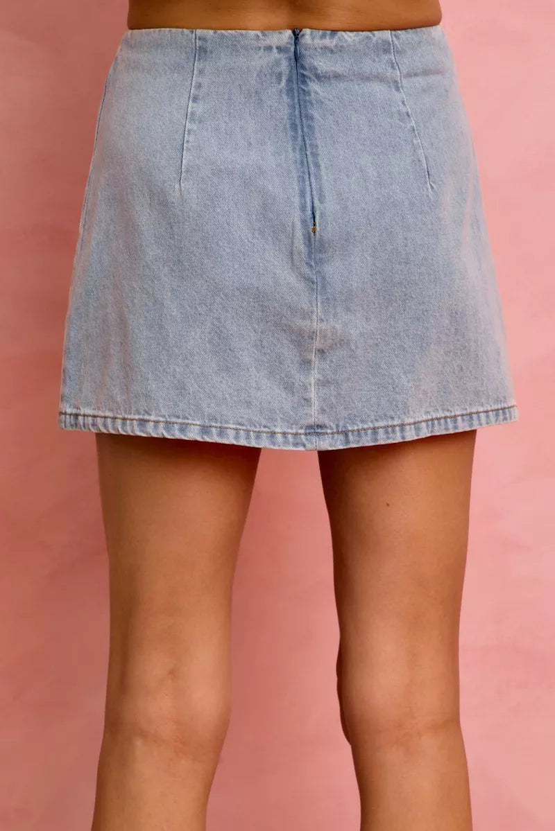 Light-wash denim mini skirt with front seam detail and straight hem