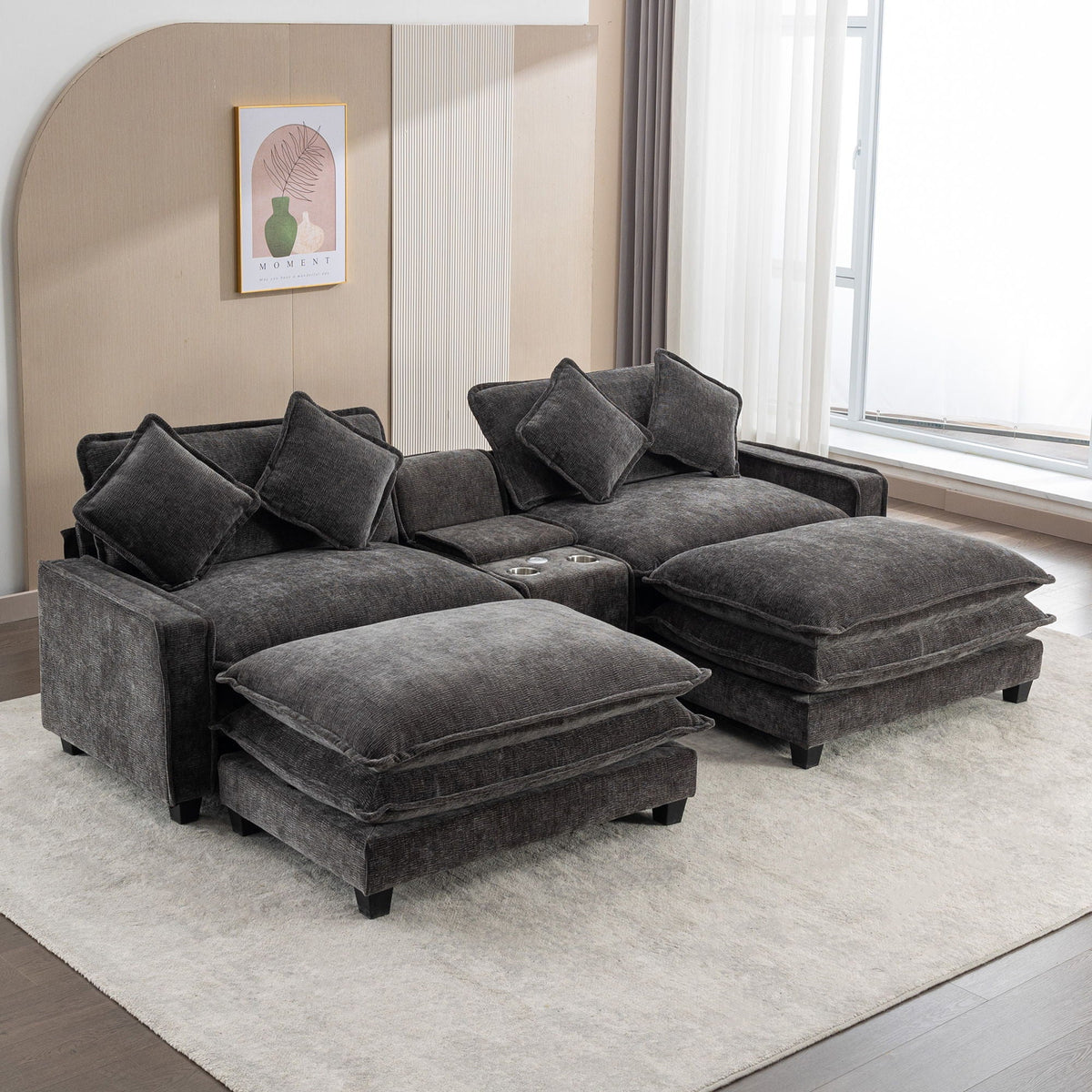 Dark gray sectional sofa with two ottomans pulled forward and three back cushions
