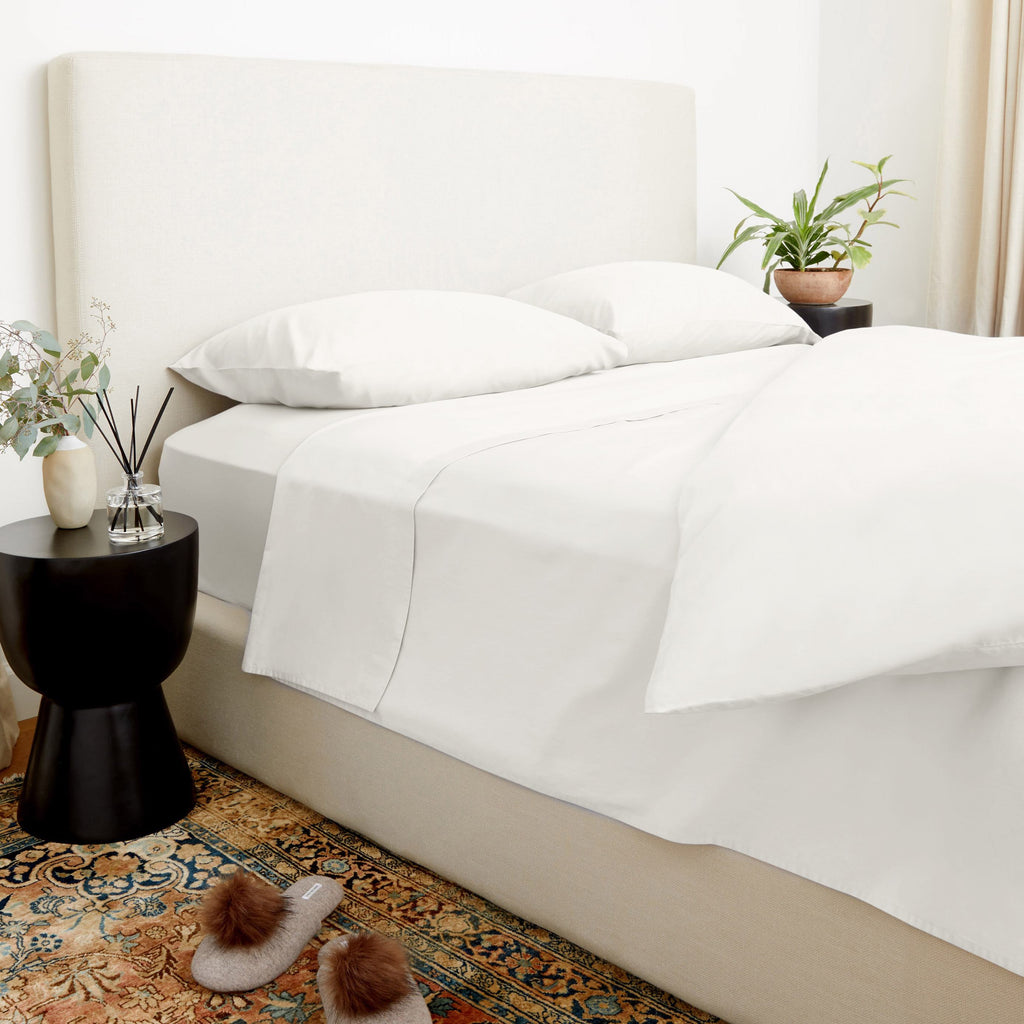 White duvet cover with two pillows and fitted sheet on a bed