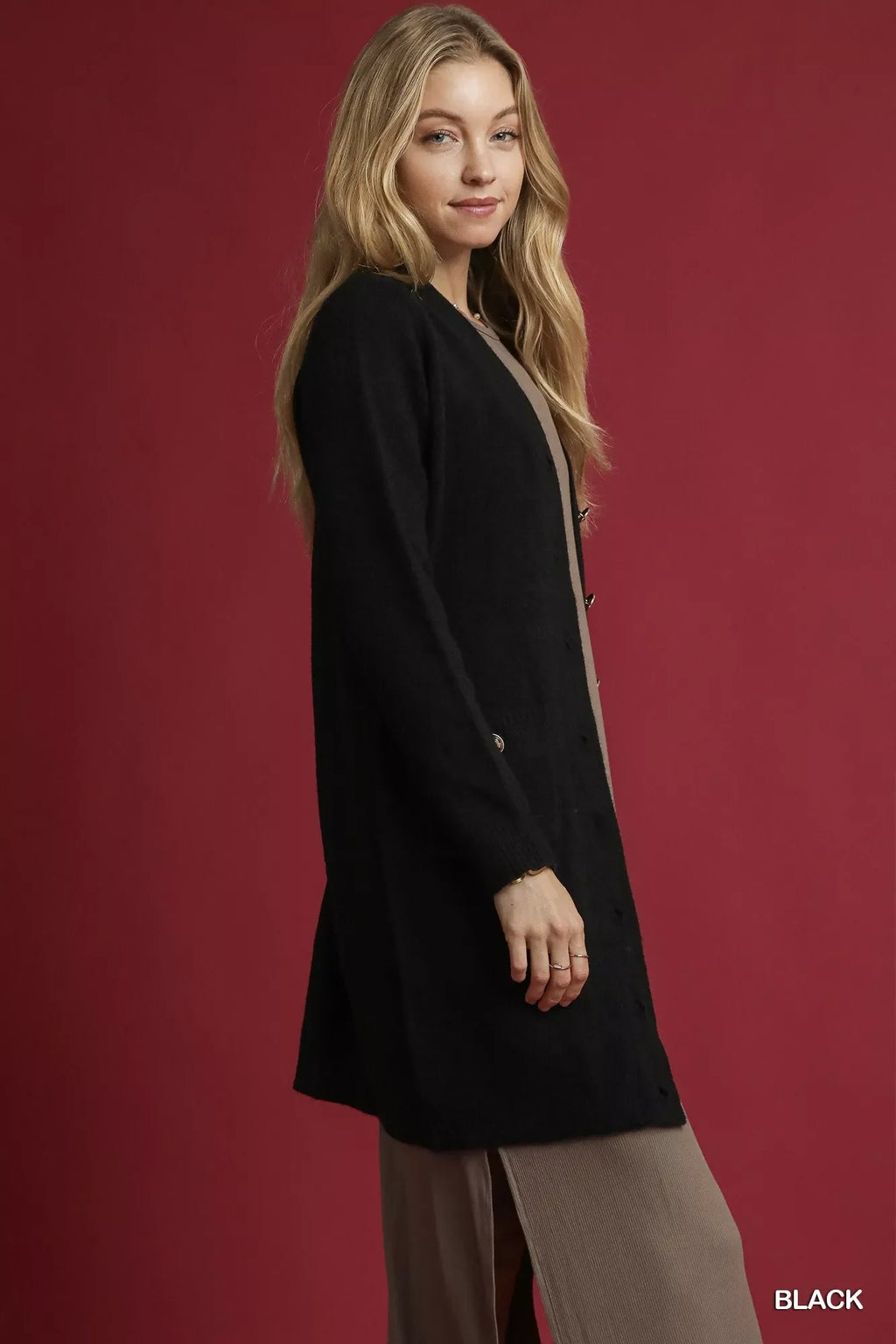 Black longline sweater cardigan with button placket, side profile