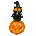 Halloween owl on pumpkin decoration with glowing digital eyes and purple striped sleeves