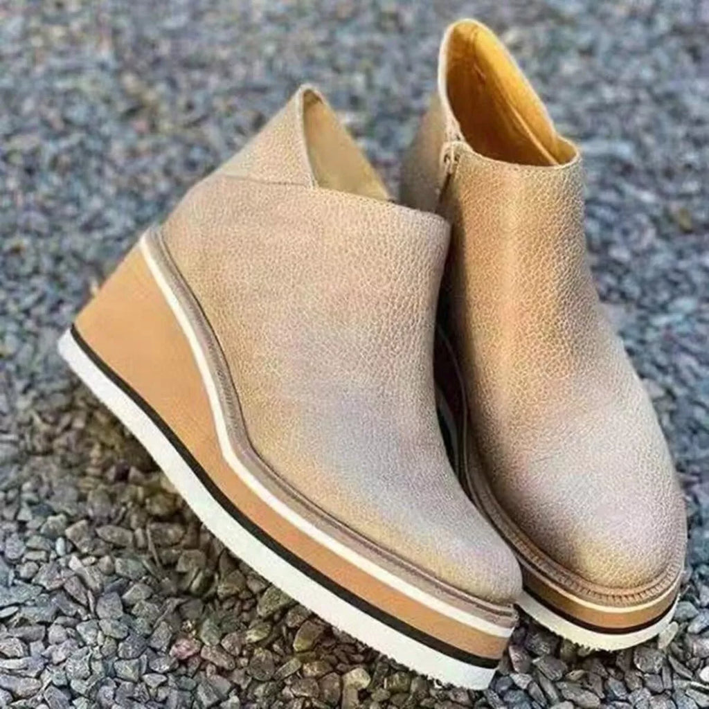 Beige ankle wedge boots with side zipper and striped platform outsole