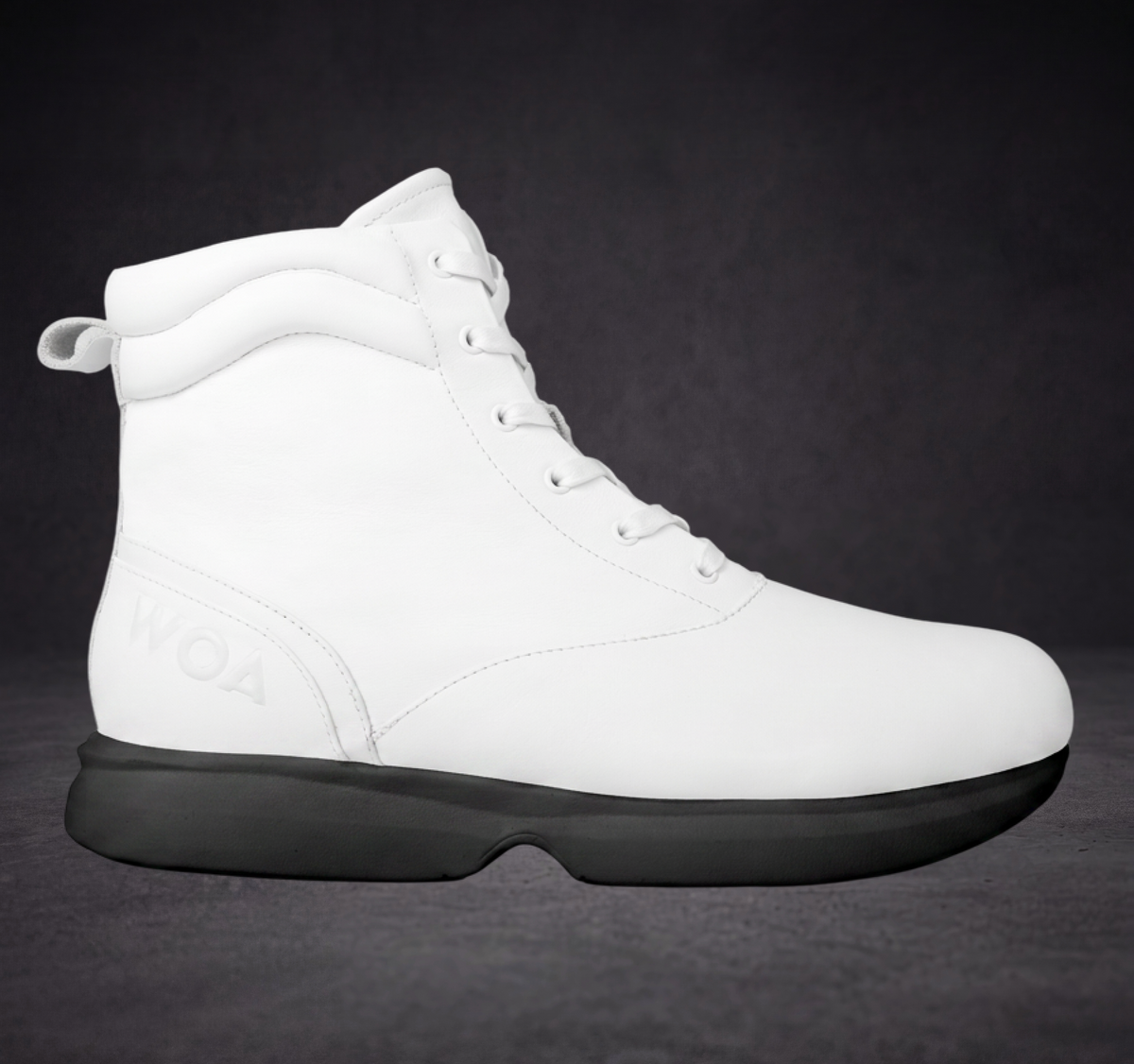 White WOA boot with lace-up front, padded collar, and black rubber sole