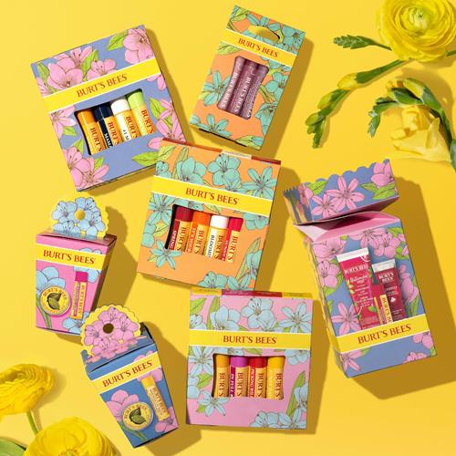 Multiple floral lip balm gift set boxes with assorted balm tube colors
