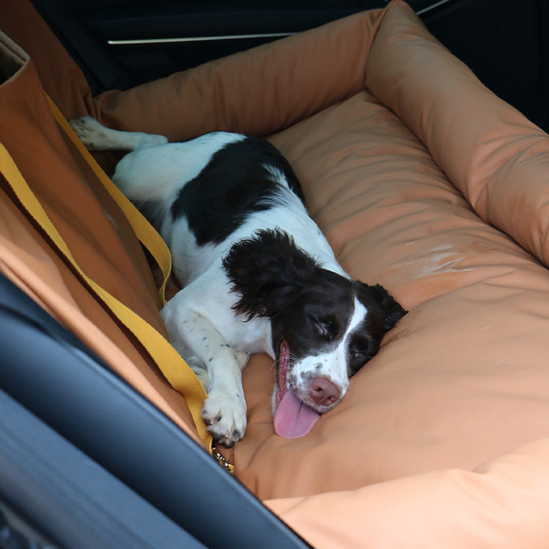 Dual-seat car dog bed with waterproof cushion, brown with yellow straps; dog resting