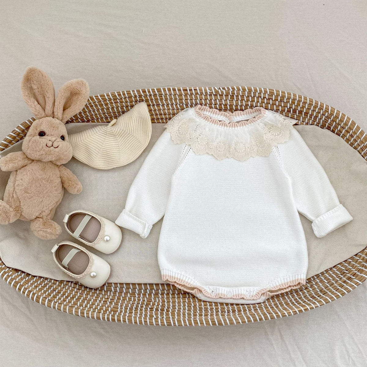 Off-white knitted baby long-sleeve romper with lace collar and scalloped neckline trim