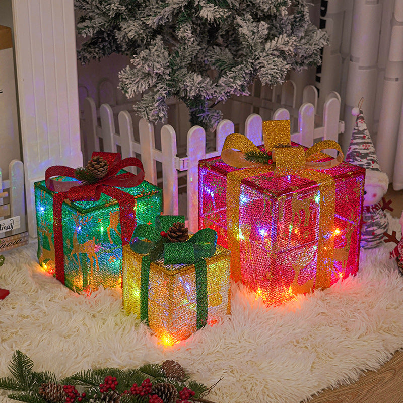 Illuminated gift boxes with multicolor ribbon bows and twinkling lights