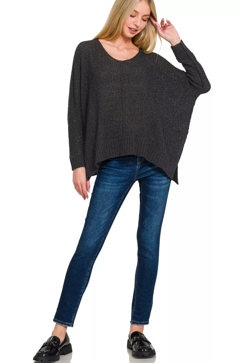 Black dolman-sleeve V-neck sweater, loose fit with long sleeves and ribbed hem