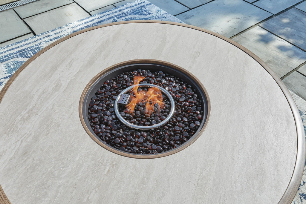 Round fire pit table top with burning flames in dark fire media inside the bowl