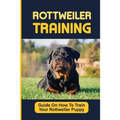 Rottweiler puppy training paperback with black-and-tan puppy on grass and yellow title text