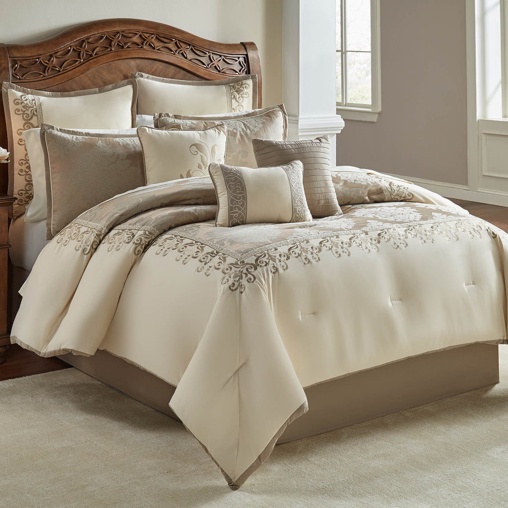 Ivory damask jacquard comforter with embroidered border and decorative pillows, styled