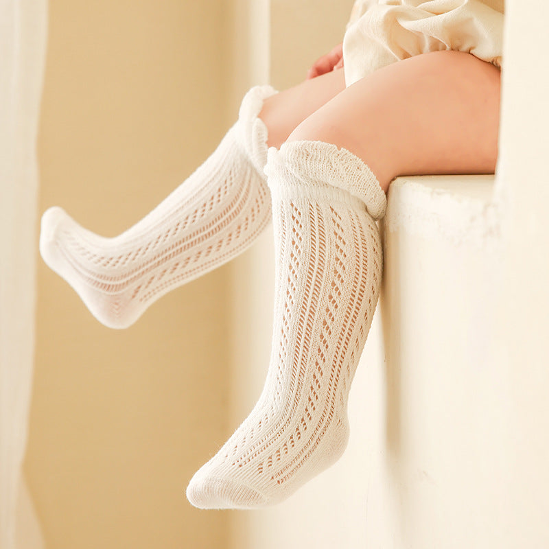 Baby lace long socks in white knit, diagonal openwork bands and ribbed cuff
