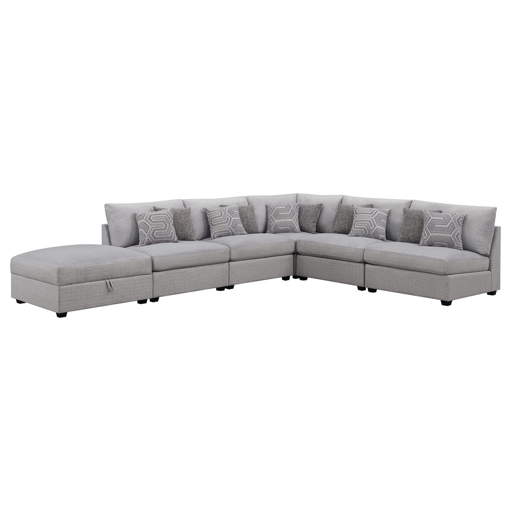 Grey modular sectional sofa with chaise and multiple geometric-pattern accent pillows