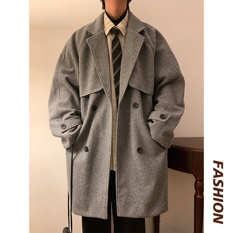 Gray mid-length wool overcoat front view with wide lapels, buttoned front, and pockets