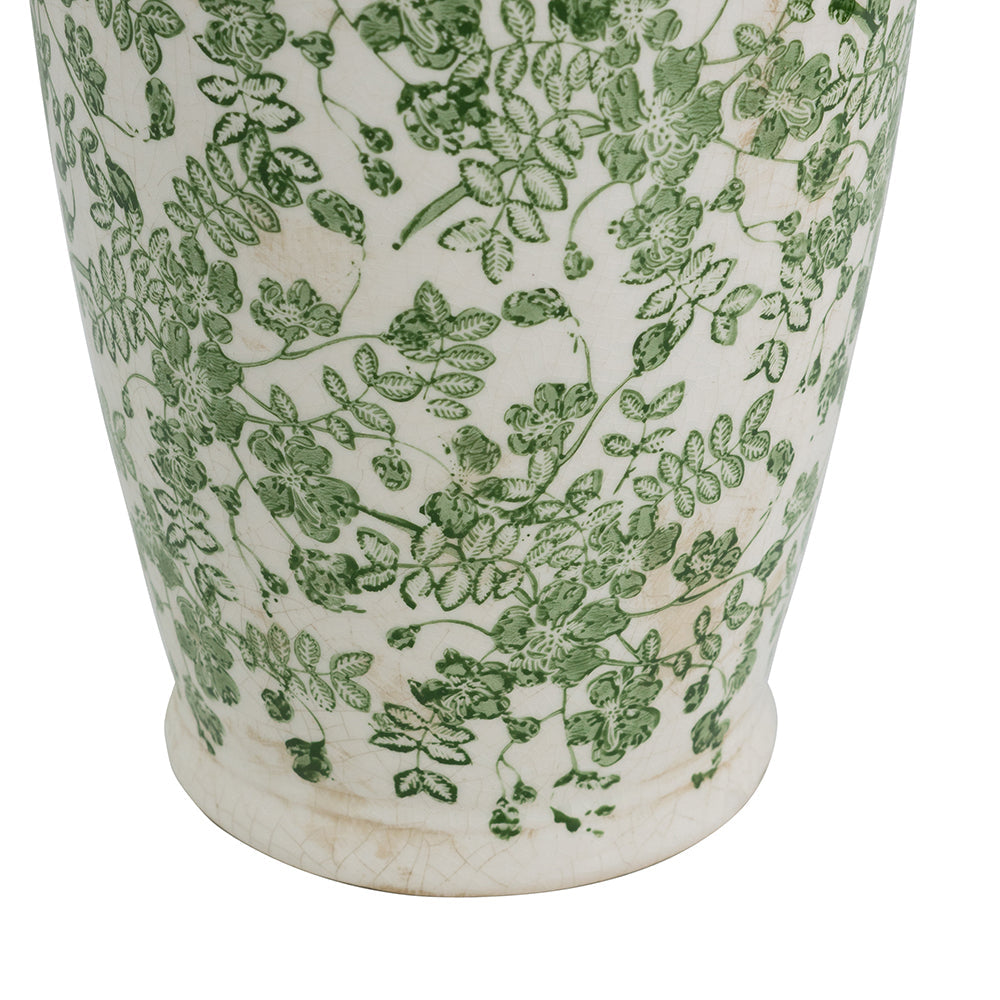 White ceramic vase with dense green leaf floral pattern and flared base