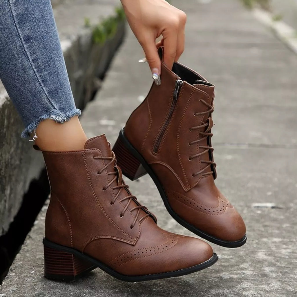 Brown lace-up ankle boots with side zipper and sturdy block heel, wingtip detailing