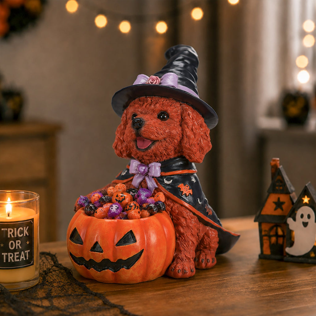 Side view of a brown dog witch figurine with a candy-filled pumpkin bowl