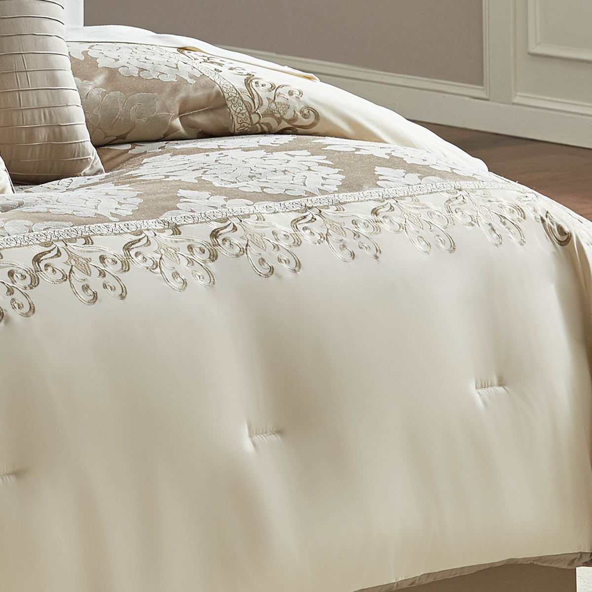 Ivory comforter with raised damask jacquard embroidery and tufted accent pillows