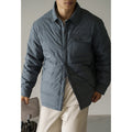 Men's short puffer jacket in gray with baseball collar, padded front, and chest pocket