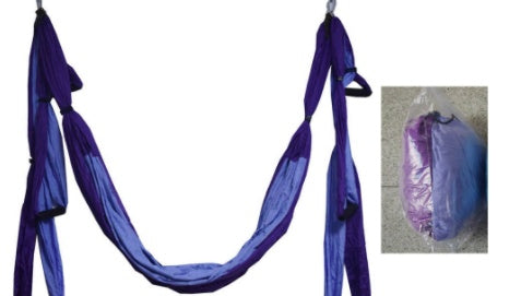 Purple yoga swing hammock with hanging fabric loops and strap ties