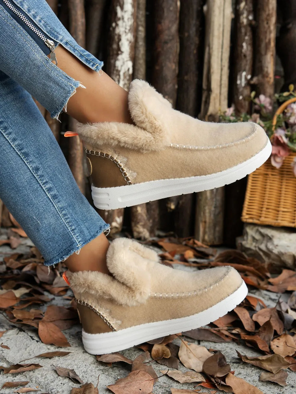 Beige suede flat sneakers with fuzzy lining, round toe and white rubber sole.
