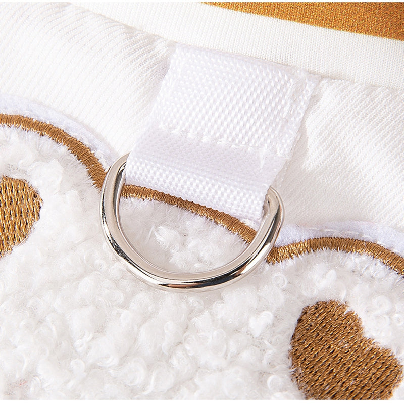 Leash ring detail on white and brown bear-pattern dog jacket