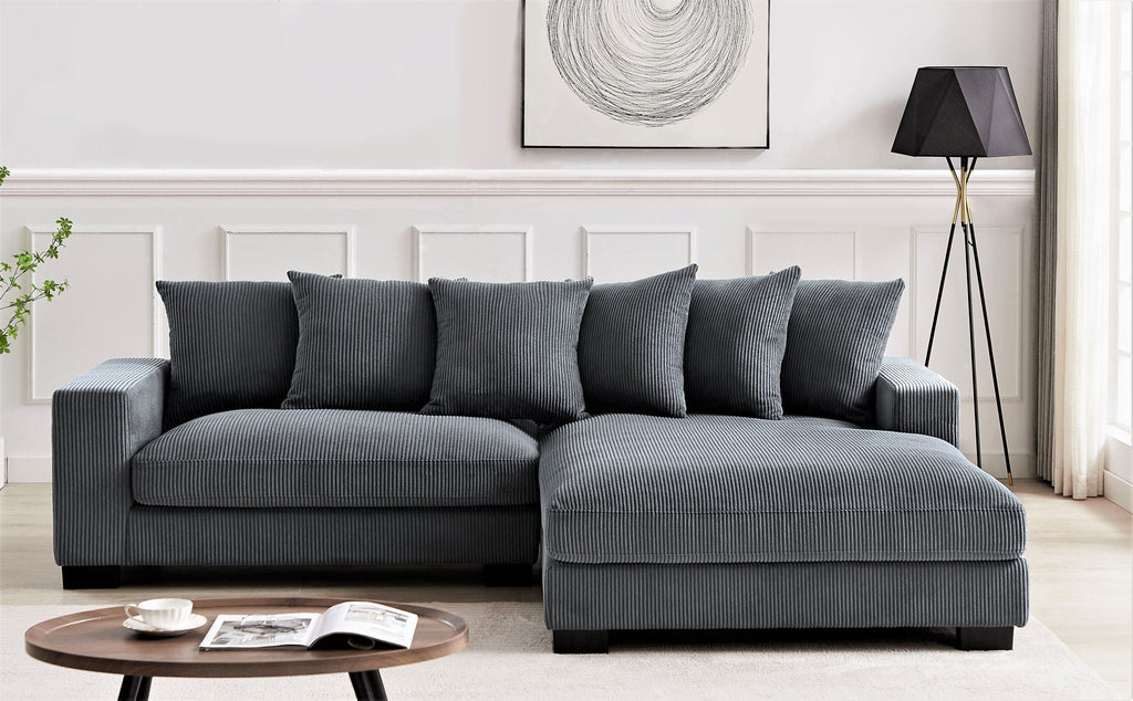 Charcoal gray L-shaped sectional sofa with chaise and matching throw pillows
