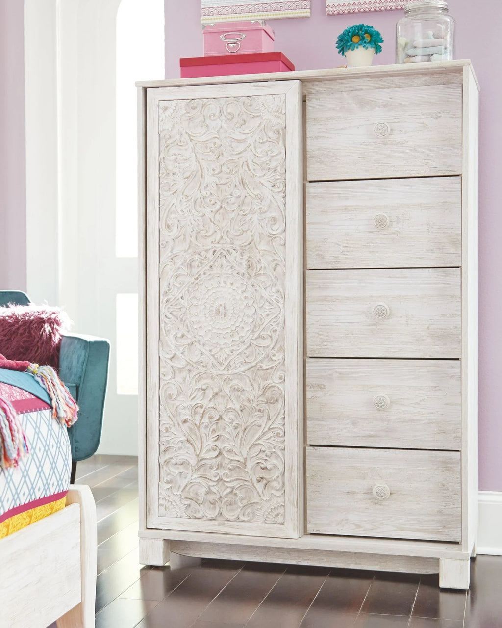 Whitewash dressing chest with embossed door panel and drawer front; open wardrobe door