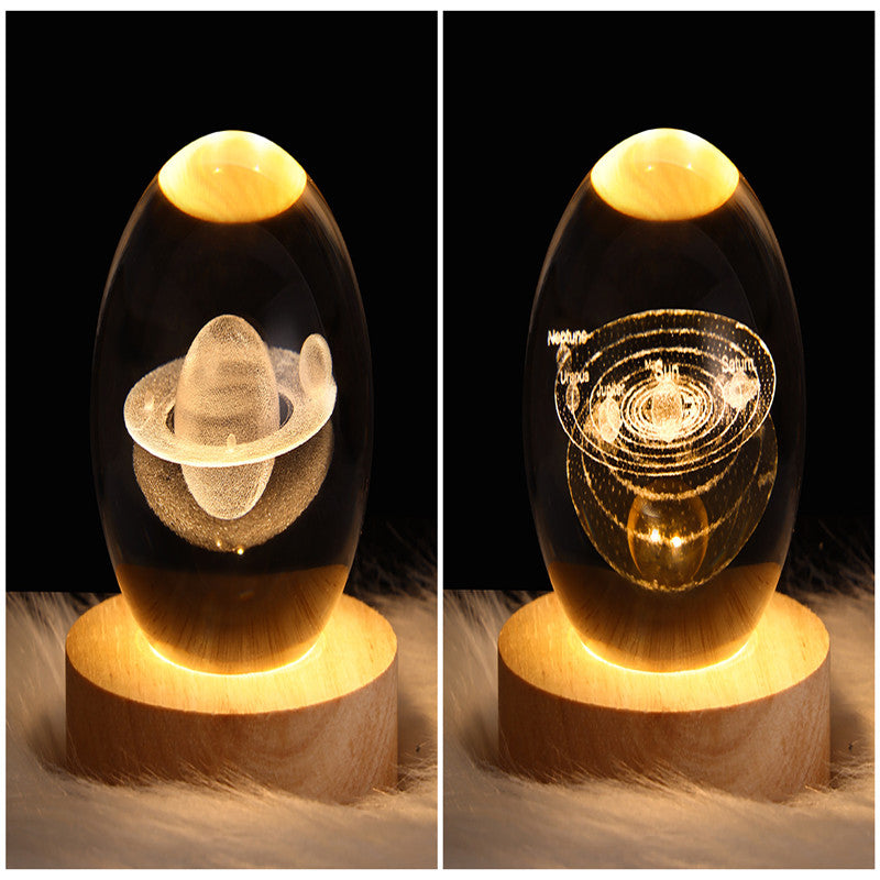 Two galaxy crystal ball table lamps with ringed planet and orbiting galaxy lights