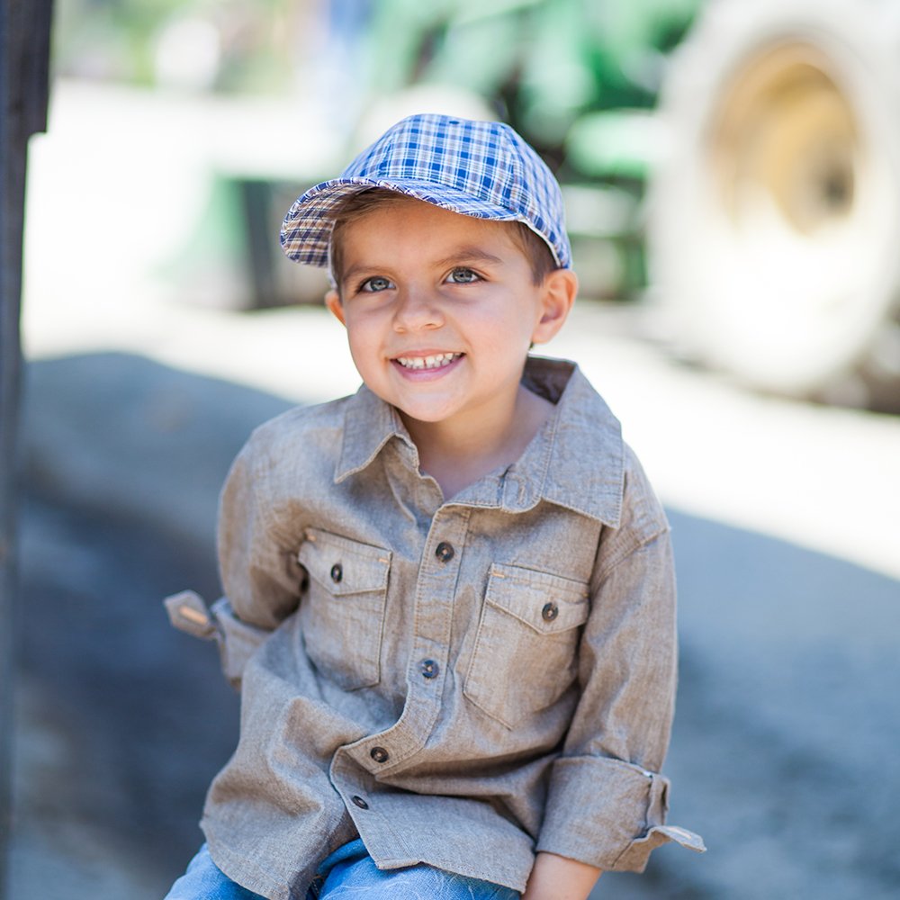 Kids blue plaid baseball cap worn by a toddler with curved brim