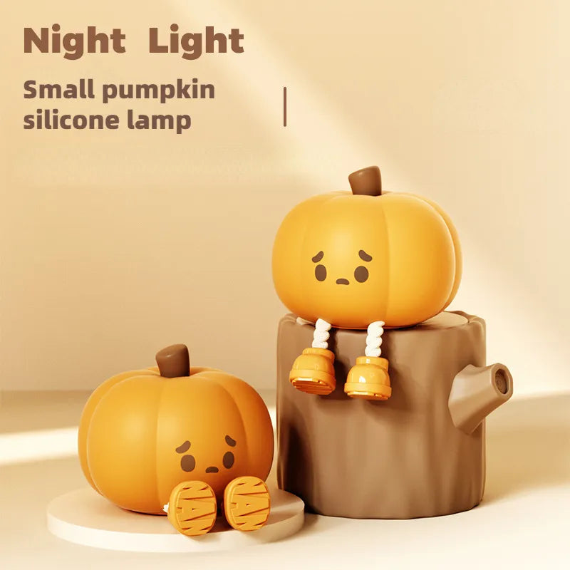 Small silicone pumpkin night light with sad face, warm glow on nightstand