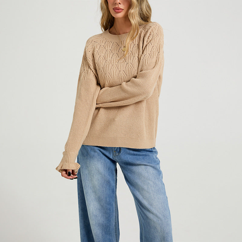 Beige womens crew-neck sweater with textured knit and long sleeves, worn with jeans