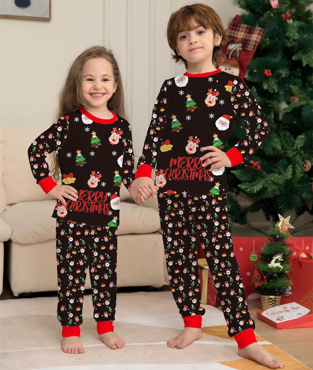 Kids Christmas pajama set in dark fabric with festive icons, red neckline trim, and cuffed legs