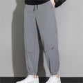 Men's tapered casual pants in light gray, drawstring waist, cuffed ankle hems