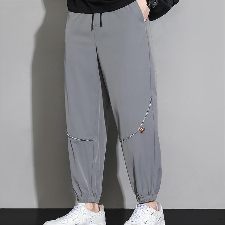 Men's tapered casual pants in light gray, drawstring waist, cuffed ankle hems