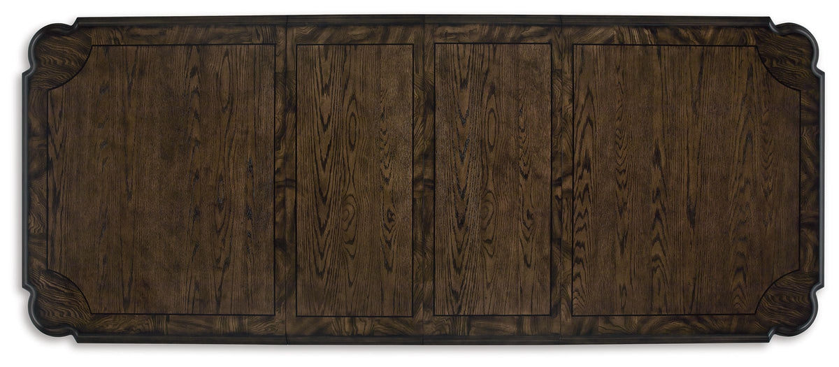 Dark brown extension table top with carved border and visible wood plank grain