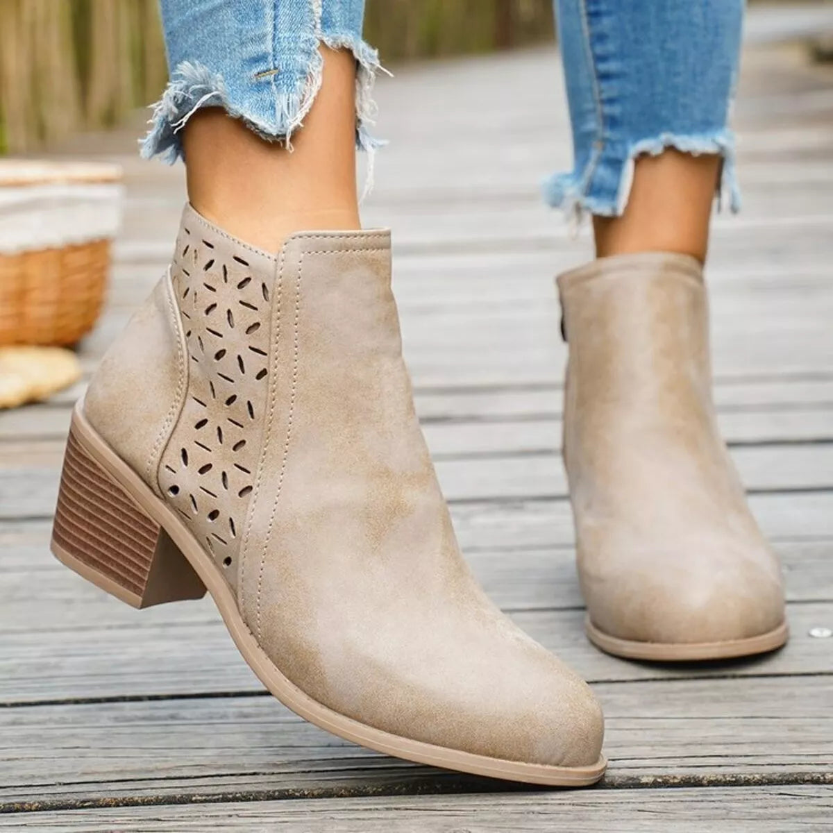 Beige ankle boots with block heel, cutout perforations, and pull-on design