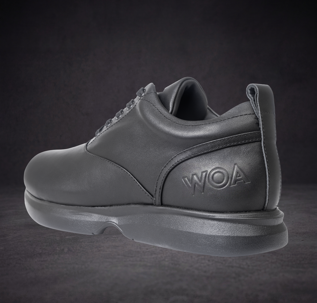 WOA low-top sneaker heel and side view, dark leather with WOA logo