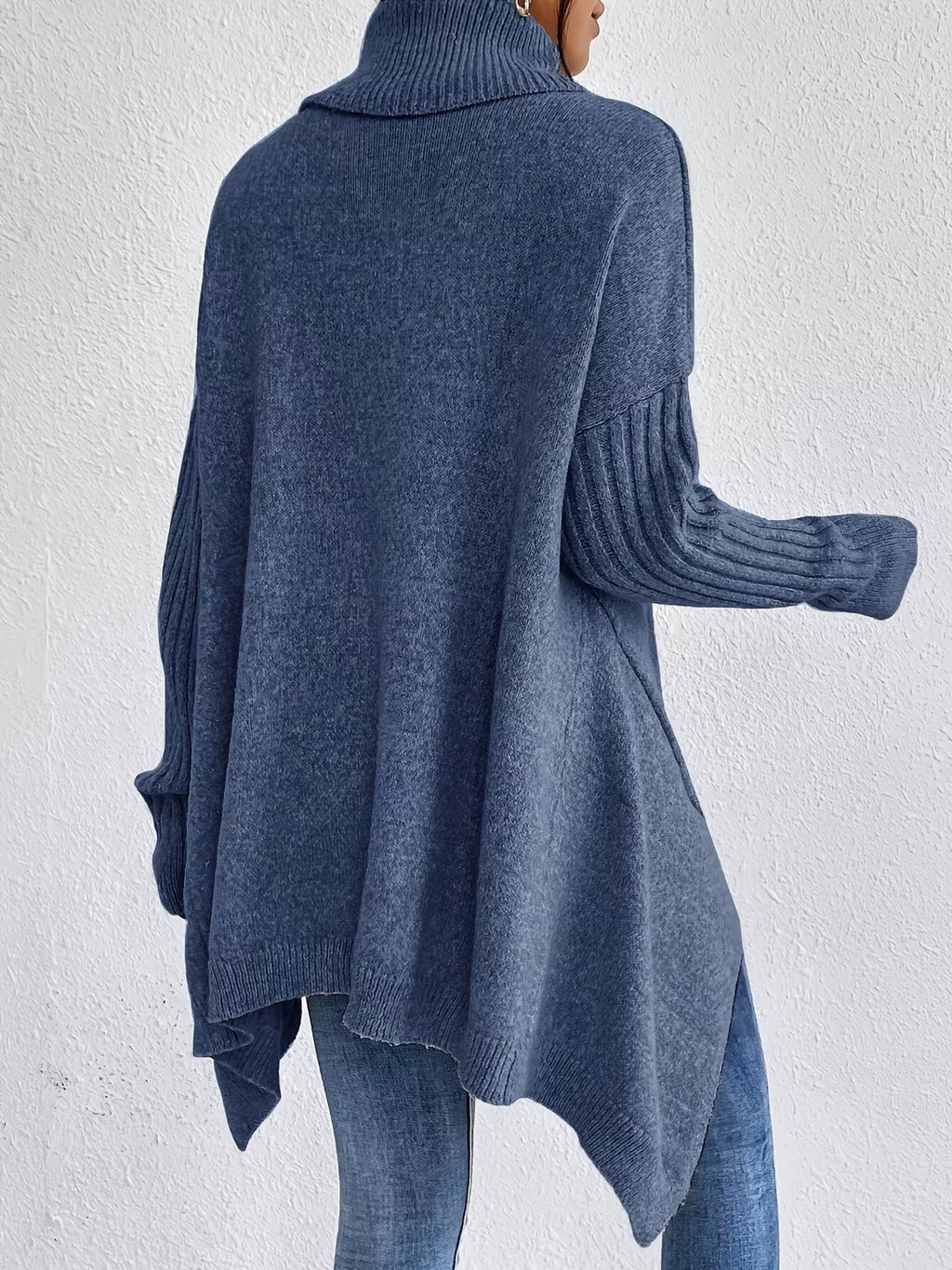 Navy turtleneck sweater viewed from back with high-low hem and ribbed sleeves