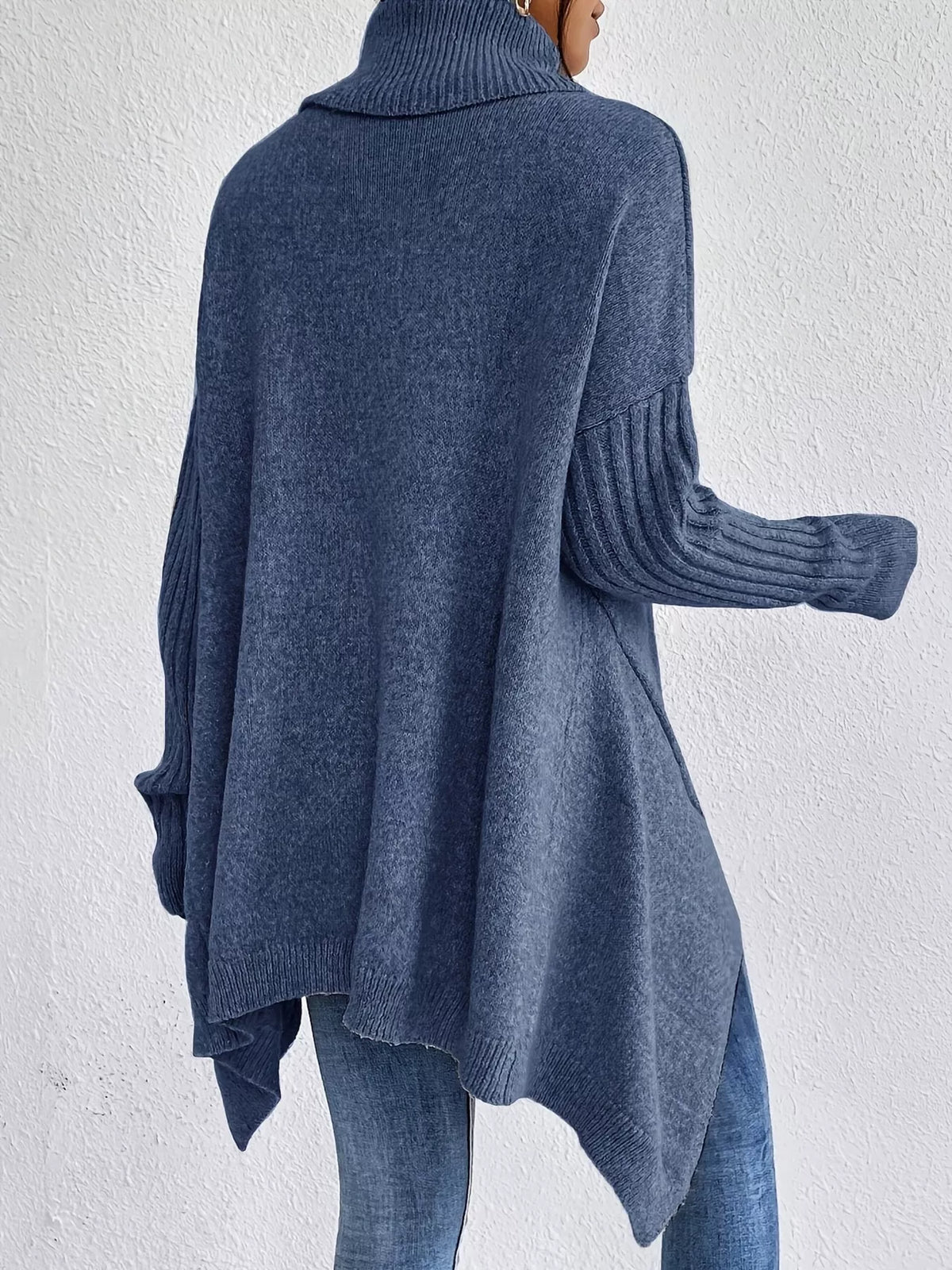 Navy turtleneck sweater viewed from back with high-low hem and ribbed sleeves