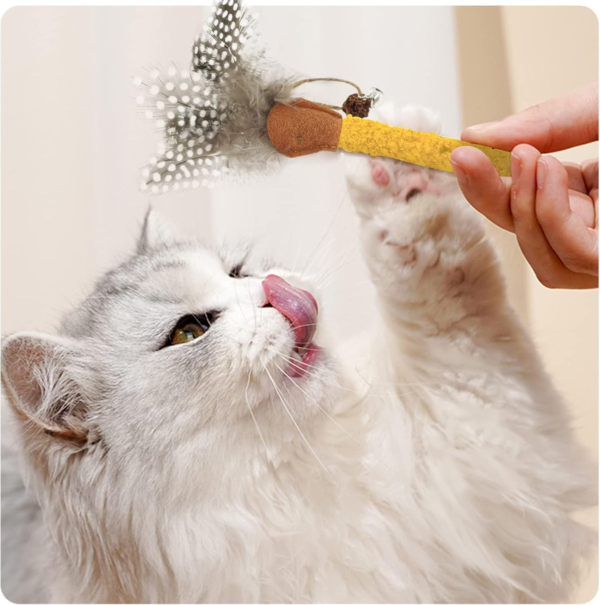 Cat chew stick toy with yellow textured wand, brown felt tip, and gray feather sprig