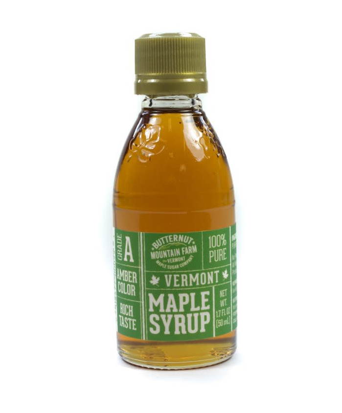 Amber maple syrup in glass bottle with gold cap, front label visible