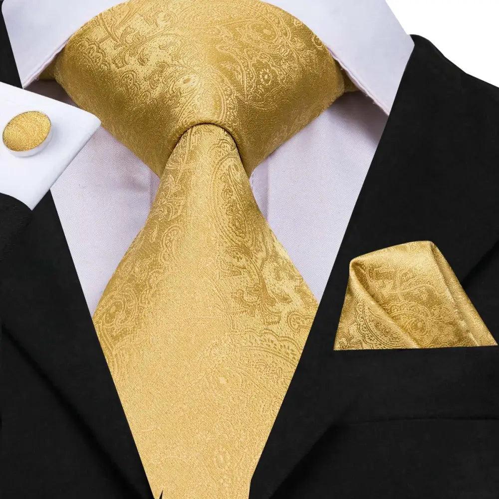 Men's gold patterned tie set with matching pocket square and cufflinks